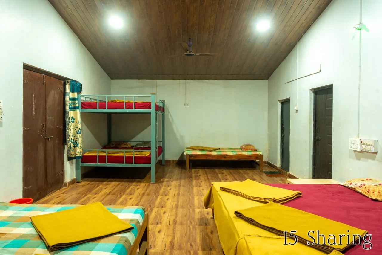 Deluxe suite interior with comfortable bedding at the Dandeli resort